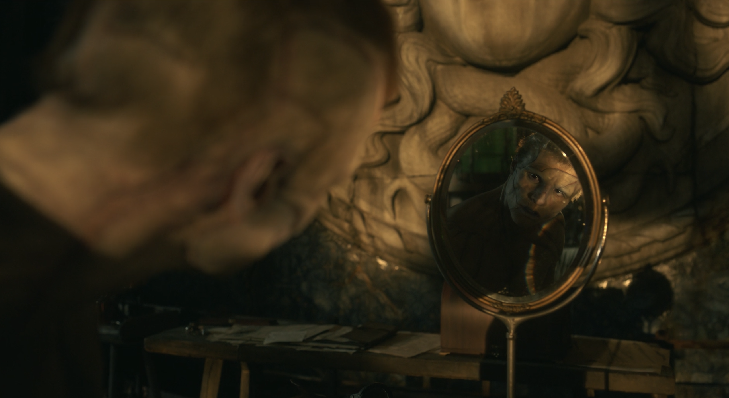 Jacob Elordi's character in del Toro's Frankenstein  looks at himself 
